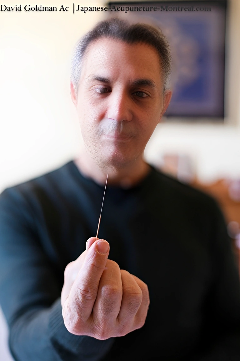Focused man examining acupuncture tool