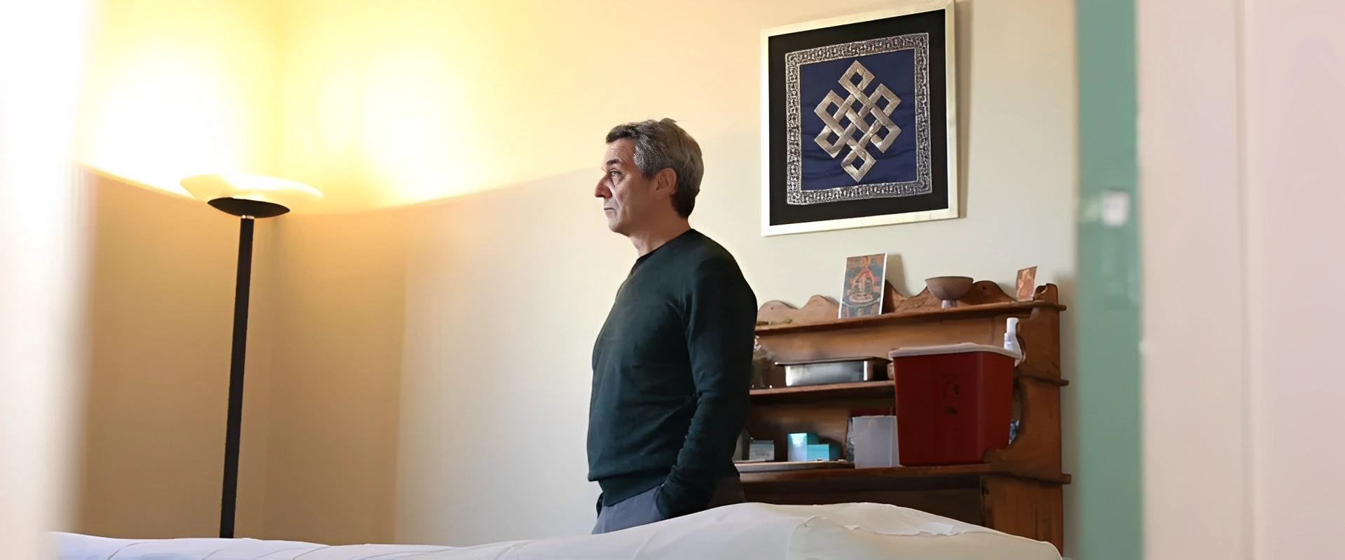 Individual in front of a framed artwork